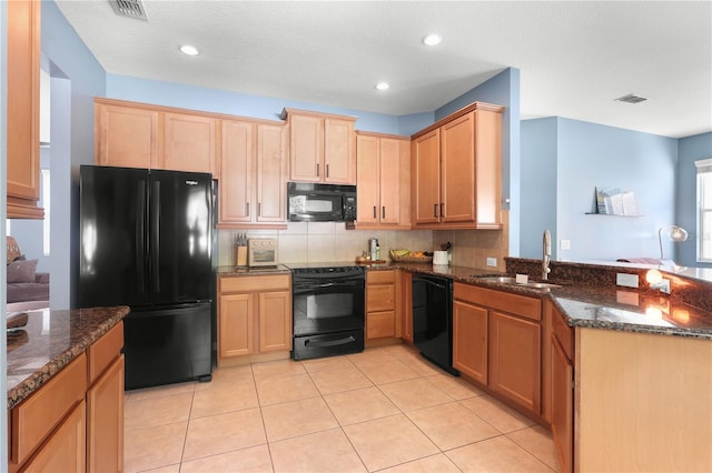 2762 Pepper Ln, Orlando, FL 32812 - kitchen with black appliances, a sink, a peninsula, light brown cabinetry, and recessed lighting
