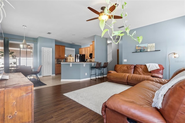 2762 Pepper Ln, Orlando, FL 32812 - living area featuring a ceiling fan, wood finished floors, and baseboards