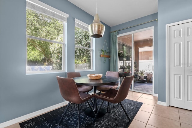 2762 Pepper Ln, Orlando, FL 32812 - dining room with light tile patterned floors and baseboards