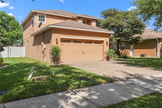 2762 Pepper Ln, Orlando, FL 32812 - view of front of house with stucco siding, a garage, and decorative driveway