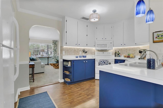 936 N Baker St, Mount Dora, FL 32757 - kitchen featuring white appliances, blue cabinets, a sink, arched walkways, and light wood finished floors