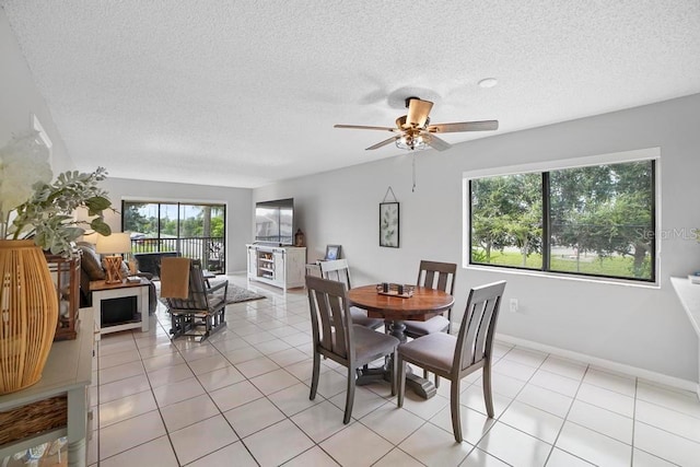 5800 N Banana River Blvd Unit 128, Cape Canaveral, FL 32920 - dining room with a textured ceiling, a ceiling fan, light tile patterned floors, and baseboards
