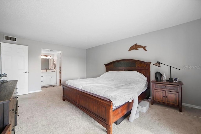 5800 N Banana River Blvd Unit 128, Cape Canaveral, FL 32920 - bedroom with light carpet, baseboards, and ensuite bath