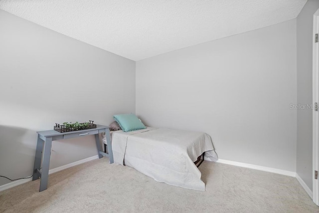 5800 N Banana River Blvd Unit 128, Cape Canaveral, FL 32920 - carpeted bedroom with baseboards and a textured ceiling