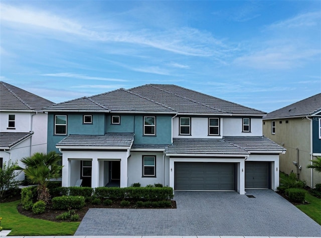 3880 Sonoma Blvd, Kissimmee, FL 34741 - traditional home with a garage, decorative driveway, stucco siding, and a tiled roof
