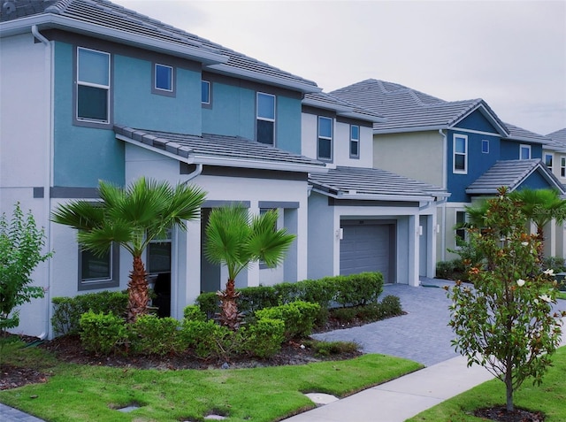 3880 Sonoma Blvd, Kissimmee, FL 34741 - view of front of property with an attached garage, stucco siding, driveway, and a tiled roof