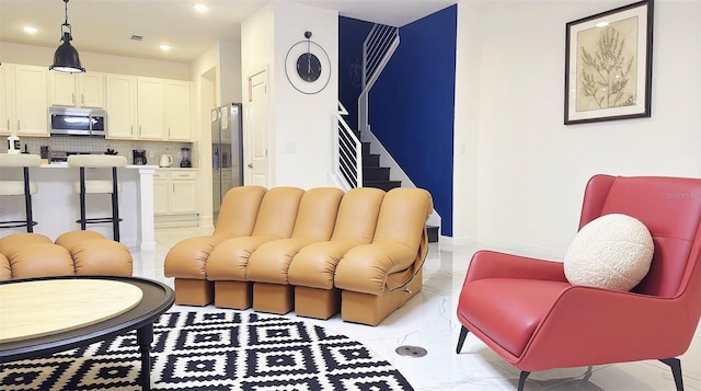 3880 Sonoma Blvd, Kissimmee, FL 34741 - living room with light marble finish floors, recessed lighting, and stairs