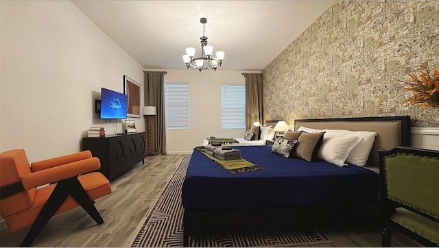 3880 Sonoma Blvd, Kissimmee, FL 34741 - bedroom with light wood-style flooring, a chandelier, wallpapered walls, and an accent wall