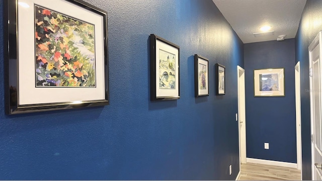 3880 Sonoma Blvd, Kissimmee, FL 34741 - hall featuring baseboards, wood finished floors, and a textured ceiling