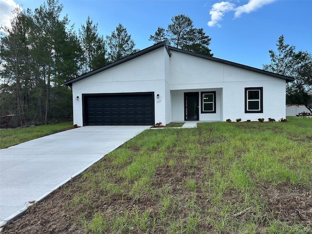 3063 SW 168th Loop, Ocala, FL 34473 - contemporary home featuring a garage, concrete driveway, a front lawn, and stucco siding