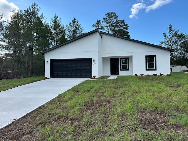 3063 SW 168th Loop, Ocala, FL 34473 - contemporary home featuring an attached garage, driveway, stucco siding, and a front lawn