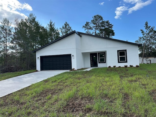3063 SW 168th Loop, Ocala, FL 34473 - contemporary home with a garage, concrete driveway, a front yard, and stucco siding