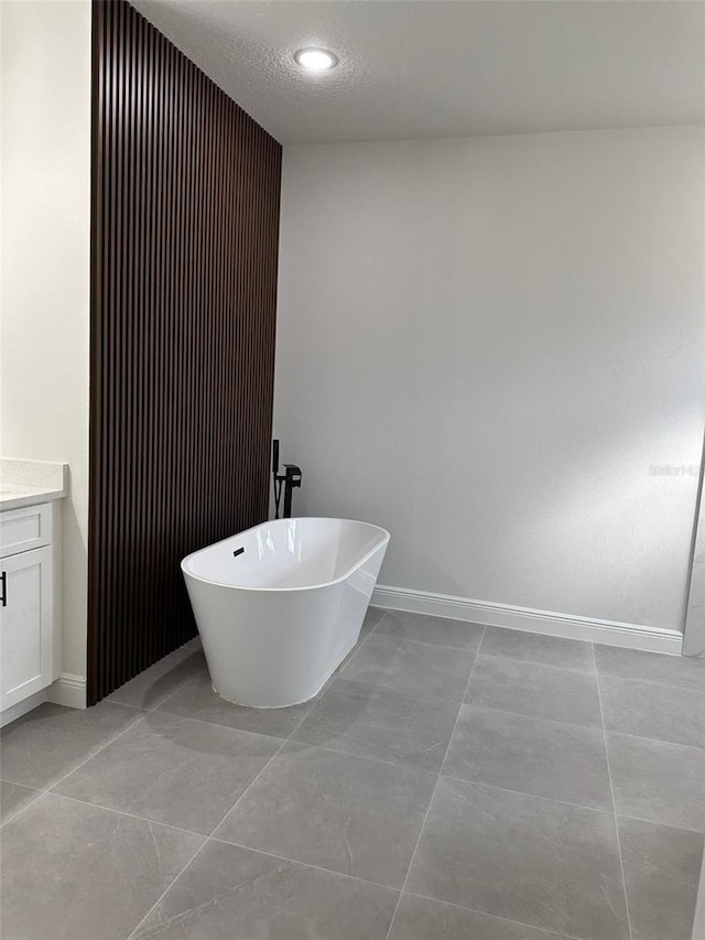 3063 SW 168th Loop, Ocala, FL 34473 - bathroom with a soaking tub, baseboards, and vanity