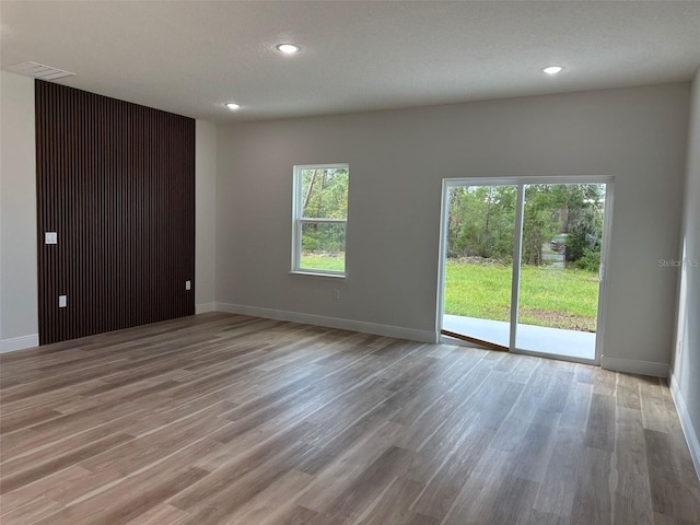 3063 SW 168th Loop, Ocala, FL 34473 - empty room featuring light wood-style flooring, plenty of natural light, baseboards, and recessed lighting