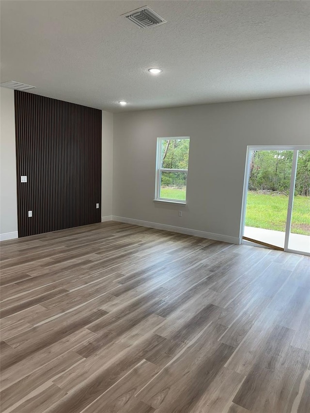 3063 SW 168th Loop, Ocala, FL 34473 - unfurnished room with wood finished floors, baseboards, a textured ceiling, and recessed lighting