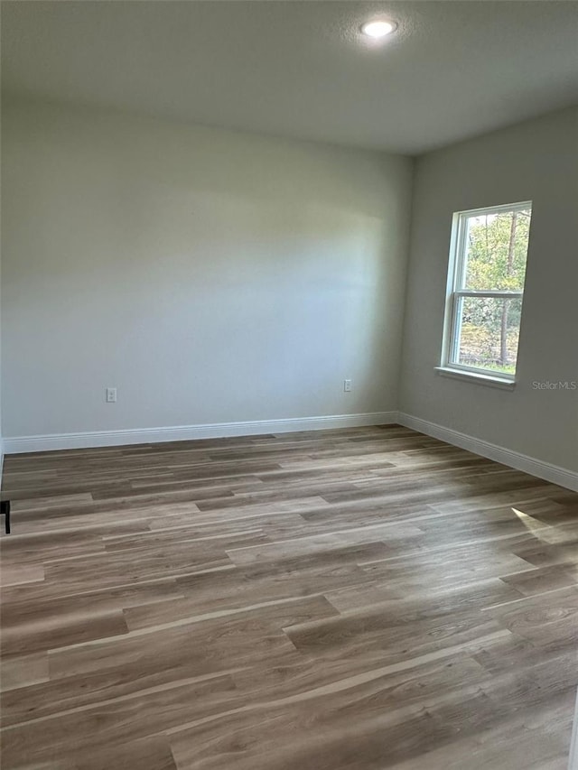 3063 SW 168th Loop, Ocala, FL 34473 - unfurnished room with baseboards, wood finished floors, and recessed lighting