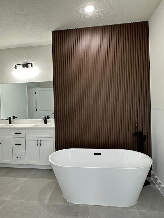 3063 SW 168th Loop, Ocala, FL 34473 - bathroom with double vanity, a soaking tub, a textured ceiling, and recessed lighting