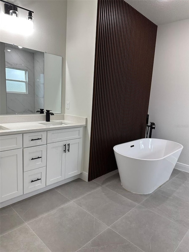 3063 SW 168th Loop, Ocala, FL 34473 - full bath featuring a freestanding tub, double vanity, baseboards, a walk in shower, and tile patterned floors