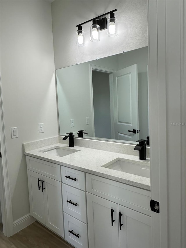 3063 SW 168th Loop, Ocala, FL 34473 - full bath featuring double vanity, wood finished floors, and baseboards