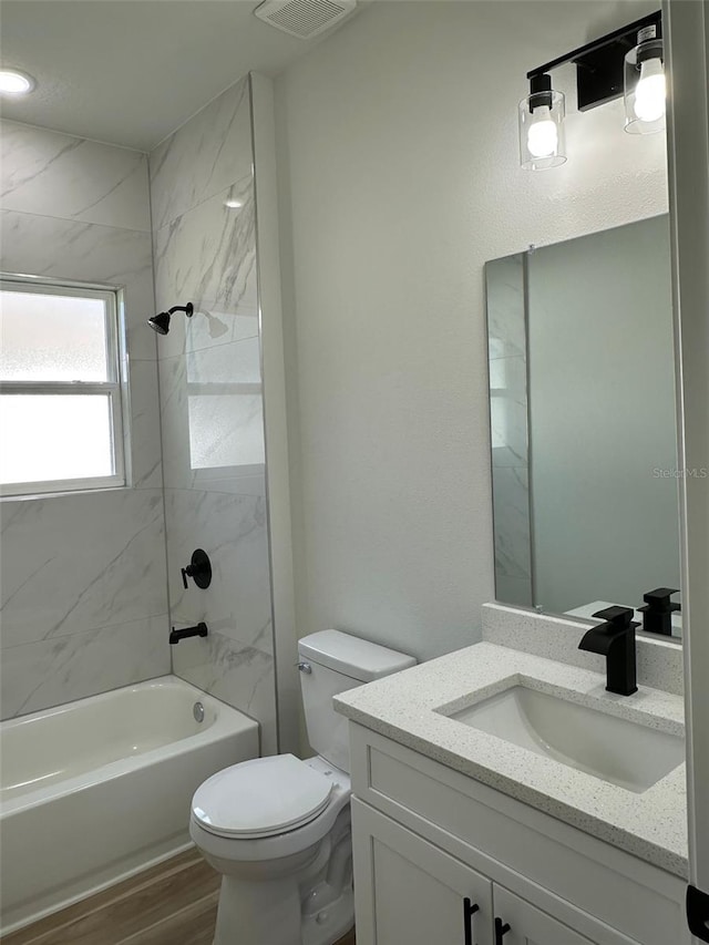 3063 SW 168th Loop, Ocala, FL 34473 - bathroom featuring vanity, shower / bathtub combination, toilet, and wood finished floors
