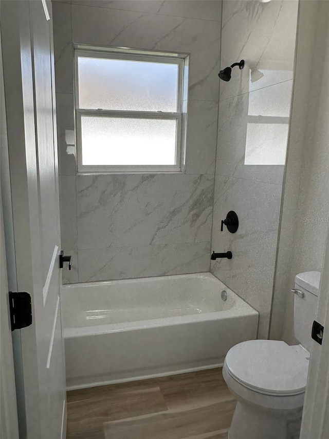 3063 SW 168th Loop, Ocala, FL 34473 - bathroom featuring toilet, wood finished floors, and bathing tub / shower combination