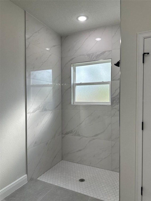3063 SW 168th Loop, Ocala, FL 34473 - bathroom featuring tiled shower, a textured ceiling, and recessed lighting