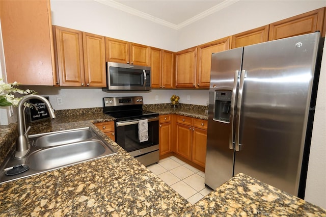 2493 Lancien Ct Unit 5, Orlando, FL 32826 - kitchen with stainless steel appliances, dark countertops, brown cabinetry, crown molding, and light tile patterned flooring