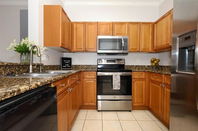 2493 Lancien Ct Unit 5, Orlando, FL 32826 - kitchen with stainless steel appliances, ornamental molding, light tile patterned flooring, and brown cabinetry
