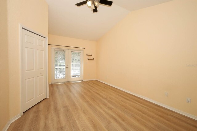 2493 Lancien Ct Unit 5, Orlando, FL 32826 - empty room with vaulted ceiling, a ceiling fan, light wood-style floors, and french doors