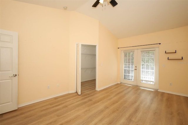 2493 Lancien Ct Unit 5, Orlando, FL 32826 - unfurnished bedroom featuring french doors, access to outside, lofted ceiling, light wood-style floors, and a spacious closet