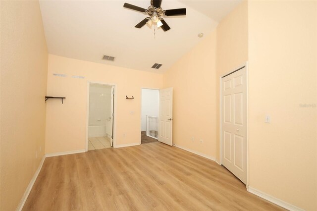 2493 Lancien Ct Unit 5, Orlando, FL 32826 - unfurnished bedroom featuring light wood finished floors, connected bathroom, high vaulted ceiling, a closet, and a ceiling fan