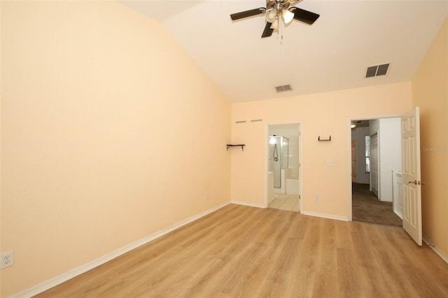2493 Lancien Ct Unit 5, Orlando, FL 32826 - unfurnished bedroom with vaulted ceiling, light wood-style flooring, ensuite bath, ceiling fan, and freestanding refrigerator