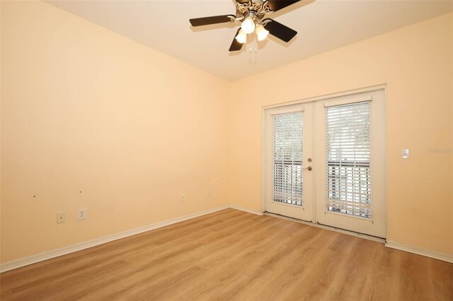 2493 Lancien Ct Unit 5, Orlando, FL 32826 - empty room with light wood finished floors, ceiling fan, and french doors