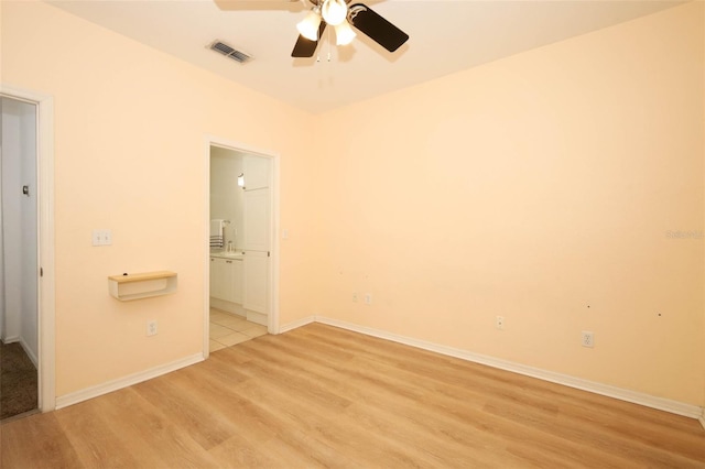 2493 Lancien Ct Unit 5, Orlando, FL 32826 - unfurnished bedroom featuring light wood-style flooring, connected bathroom, and ceiling fan