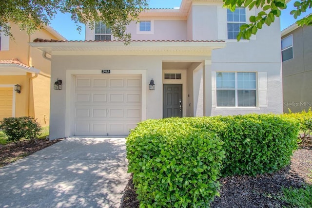 view of front of home featuring stucco siding, driveway, and an attached garage