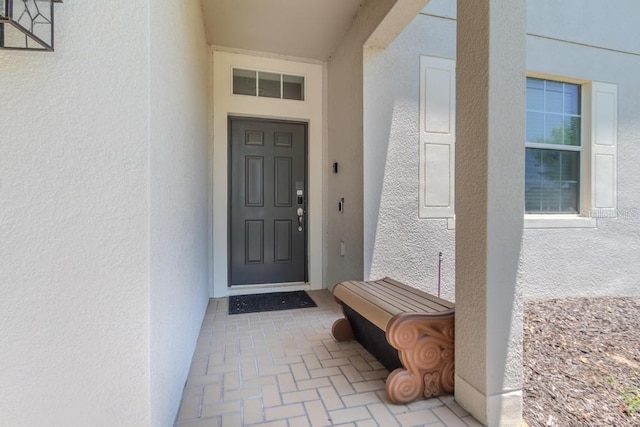 property entrance featuring stucco siding