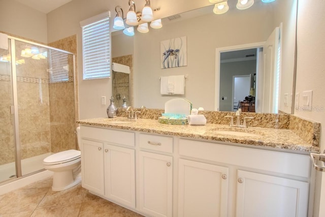 bathroom featuring a chandelier, a shower stall, double vanity, and toilet