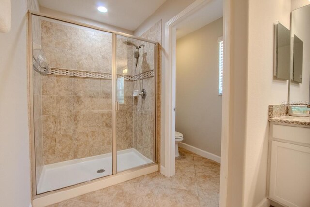 full bath featuring a shower stall, toilet, tile patterned floors, and vanity