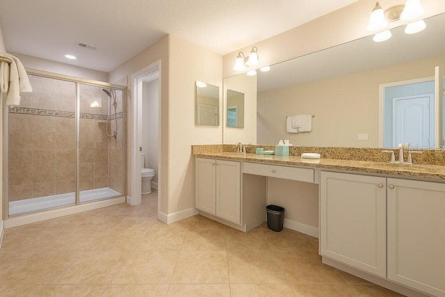 full bath featuring a shower stall, toilet, double vanity, tile patterned flooring, and baseboards