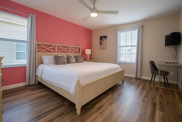 bedroom featuring dark wood-style floors, baseboards, and ceiling fan