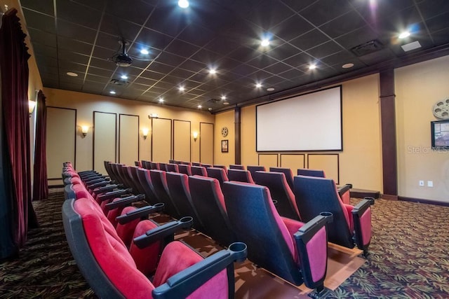 home theater featuring carpet, baseboards, and a paneled ceiling