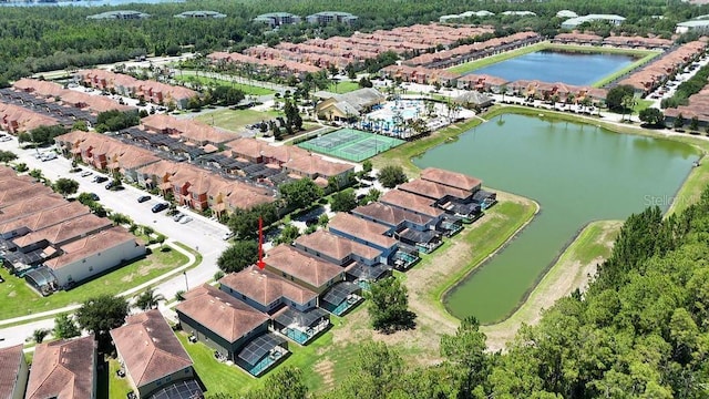aerial view of property's location featuring a large body of water and nearby suburban area