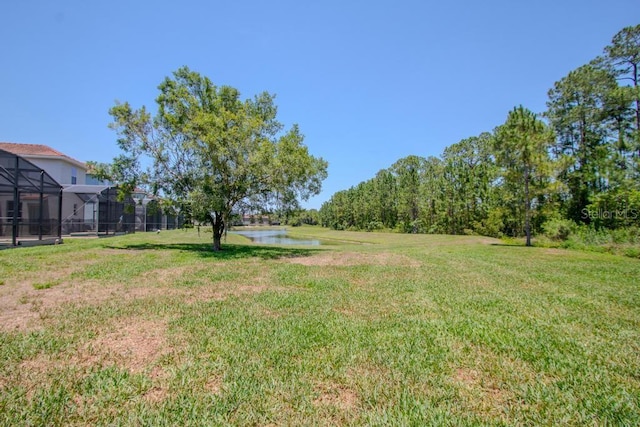 view of grassy yard with a water view