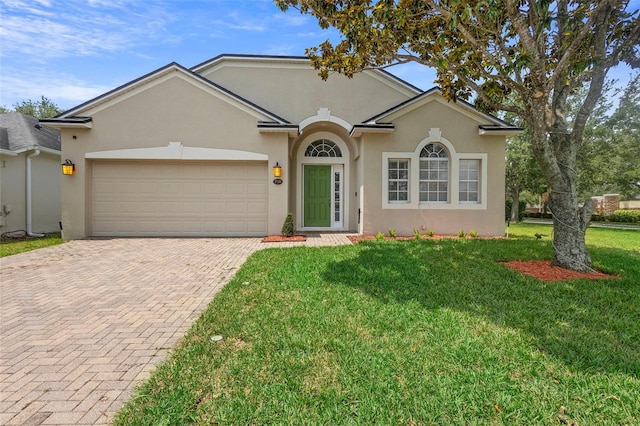 714 Home Grove Dr, Winter Garden, FL 34787 - view of front of property with decorative driveway, stucco siding, a garage, and a front lawn