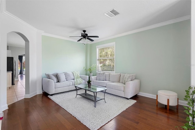714 Home Grove Dr, Winter Garden, FL 34787 - living area with arched walkways, ceiling fan, dark wood finished floors, ornamental molding, and baseboards
