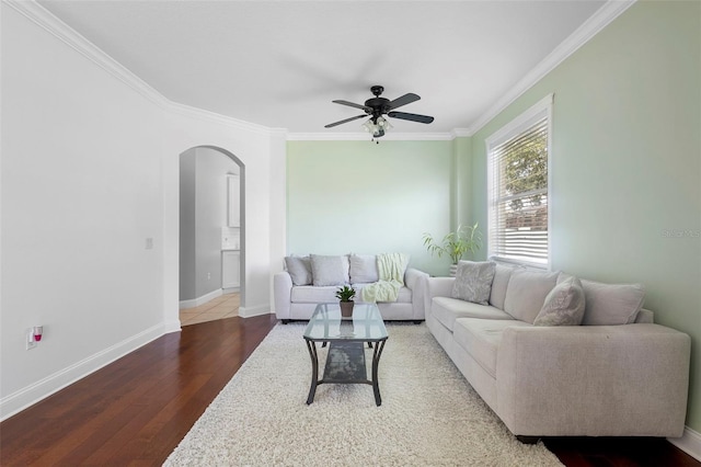 714 Home Grove Dr, Winter Garden, FL 34787 - living room featuring arched walkways, ornamental molding, wood finished floors, a ceiling fan, and baseboards