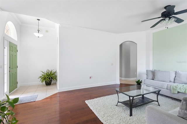 714 Home Grove Dr, Winter Garden, FL 34787 - living room with arched walkways, crown molding, wood finished floors, ceiling fan, and baseboards