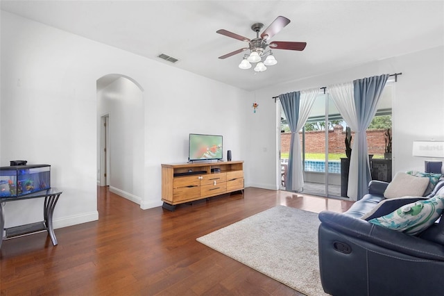 714 Home Grove Dr, Winter Garden, FL 34787 - living area with arched walkways, ceiling fan, wood finished floors, and baseboards