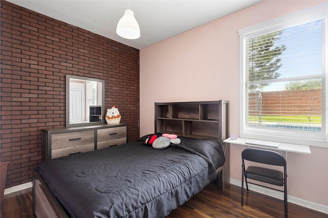 714 Home Grove Dr, Winter Garden, FL 34787 - bedroom featuring brick wall, wood finished floors, and baseboards