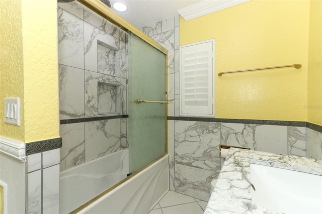 645 Peachwood Dr, Altamonte Springs, FL 32714 - bathroom with bath / shower combo with glass door, crown molding, a textured wall, vanity, and tile walls
